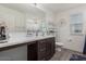 Bathroom featuring a modern vanity, a mirror, and a window providing natural light at 10986 W Polk St, Avondale, AZ 85323