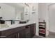 Stylish bathroom with double vanity, dark cabinets, and modern fixtures at 10986 W Polk St, Avondale, AZ 85323