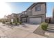 Exterior view of a two-story home featuring a gray garage door and desert landscaping at 10986 W Polk St, Avondale, AZ 85323
