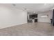 Open-concept living room leading to a modern kitchen, featuring sleek tile floors and recessed lighting at 10986 W Polk St, Avondale, AZ 85323