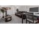 Living room featuring a plush sofa, desk, and decorative accents at 10986 W Polk St, Avondale, AZ 85323