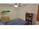 Bright bedroom featuring a crib, bookcase, and ample closet space for a functional and cozy environment at 11265 E Contessa St, Mesa, AZ 85207