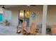 Relaxing covered patio with ceiling fans, decorative gecko art and cozy wooden rocking chairs at 11265 E Contessa St, Mesa, AZ 85207