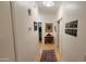 Bright hallway with hardwood floors, decorated with framed art and a display cabinet at 11265 E Contessa St, Mesa, AZ 85207