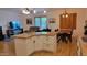 Open-concept living space with granite kitchen island, dining table and view to living room with comfortable seating at 11265 E Contessa St, Mesa, AZ 85207