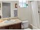 Cozy bathroom features a decorative mirror, sink with vanity, shower/tub combo and natural lighting at 11454 W St John Rd, Surprise, AZ 85378