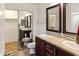 Bathroom features a double sink vanity with granite countertops and decorative framed mirrors, with a walk in closet visible at 11454 W St John Rd, Surprise, AZ 85378