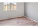 Bedroom features wood-look floors, neutral walls and a large window overlooking the exterior at 11454 W St John Rd, Surprise, AZ 85378