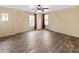 Neutral-toned bedroom featuring wood-look tile floors, ceiling fan, and arched windows at 11454 W St John Rd, Surprise, AZ 85378
