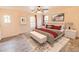 Cozy bedroom with plush bedding, ceiling fan, and neutral colors creating a relaxing retreat at 11454 W St John Rd, Surprise, AZ 85378