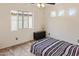 Bright bedroom with neutral walls, multiple windows, wood-look floors and a ceiling fan at 11454 W St John Rd, Surprise, AZ 85378