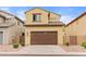 Exterior shot of a home with a two-car garage and well-maintained landscaping at 11454 W St John Rd, Surprise, AZ 85378