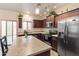 Stylish kitchen with stainless steel appliances, wooden cabinets, and a kitchen island at 11454 W St John Rd, Surprise, AZ 85378