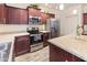 Modern kitchen featuring stainless steel appliances, wooden cabinets, and countertops at 11454 W St John Rd, Surprise, AZ 85378