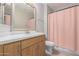 Bathroom featuring wood cabinets, a white countertop, a vanity mirror, and a shower with a pink curtain at 11640 N Tatum Blvd # 1031, Phoenix, AZ 85028