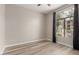 Bright bedroom with wood-look floors, neutral walls, and a window with dark curtains at 11640 N Tatum Blvd # 1031, Phoenix, AZ 85028