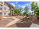 Beautiful courtyard featuring desert landscaping, a small dry creek, and a stone seating area at 11640 N Tatum Blvd # 1031, Phoenix, AZ 85028