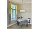 Cozy dining area featuring a modern chandelier, two chairs, and a table near the window at 11640 N Tatum Blvd # 1031, Phoenix, AZ 85028