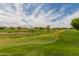Beautiful golf course view with lush green grass and blue sky at 11640 N Tatum Blvd # 1031, Phoenix, AZ 85028