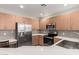 Well-lit kitchen boasts modern stainless steel appliances and wooden cabinets for a functional space at 11640 N Tatum Blvd # 1031, Phoenix, AZ 85028