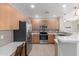 Modern kitchen equipped with stainless steel appliances, wood cabinets, and quartz countertops at 11640 N Tatum Blvd # 1031, Phoenix, AZ 85028