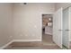 Open-concept living area featuring light-colored walls, wood-look floors, and doorway to the kitchen at 11640 N Tatum Blvd # 1031, Phoenix, AZ 85028
