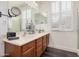 Bathroom with dual sinks, modern vanity, framed mirrors, and window with shutters at 12335 W Rosewood Ln, Peoria, AZ 85383