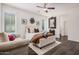 Sun-filled bedroom boasts wood floors, ceiling fan, decor, and comfortable seating at 12335 W Rosewood Ln, Peoria, AZ 85383