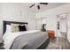 Bedroom boasts a ceiling fan, wood floors, comfortable bed, and mirrored closet at 12335 W Rosewood Ln, Peoria, AZ 85383