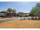 Exterior shot of the clubhouse with palm trees, desert landscaping, and a convenient drive-up area at 12335 W Rosewood Ln, Peoria, AZ 85383