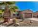 Charming home with desert landscaping, a palm tree, and neutral stucco at 12335 W Rosewood Ln, Peoria, AZ 85383