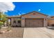 Charming single-story home with desert landscaping and a two-car garage at 12335 W Rosewood Ln, Peoria, AZ 85383