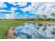 Picturesque view of a lush green golf course with a lake surrounded by trees and a mountain in the distance at 12335 W Rosewood Ln, Peoria, AZ 85383