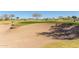 Sand bunker in a well maintained golf course with rolling green hills and flags at 12335 W Rosewood Ln, Peoria, AZ 85383