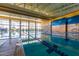 Spacious indoor pool featuring lap lanes, floor-to-ceiling windows, and contemporary design at 12335 W Rosewood Ln, Peoria, AZ 85383