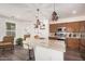Modern kitchen with marble countertops, stainless steel appliances, and stylish lighting at 12335 W Rosewood Ln, Peoria, AZ 85383