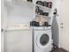 Laundry area equipped with washer, dryer, utility sink, and storage shelving at 12335 W Rosewood Ln, Peoria, AZ 85383