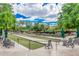 Picturesque lawn bowling area featuring lush green lanes and comfortable seating with shaded umbrellas at 12335 W Rosewood Ln, Peoria, AZ 85383