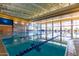 Indoor pool with lap lanes, bright natural light, and poolside seating for relaxation at 12335 W Rosewood Ln, Peoria, AZ 85383