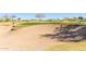 Expansive sand trap on meticulously maintained golf course surrounded by lush greenery and mature trees at 12335 W Rosewood Ln, Peoria, AZ 85383