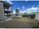 A view of the backyard with a green lawn, a house, and a scenic view of a lake at 1414 N Palmsprings Dr, Gilbert, AZ 85234