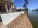 Property with water access, including a retaining wall and fence along the waterfront at 1414 N Palmsprings Dr, Gilbert, AZ 85234