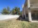 Spacious backyard with a covered patio area, partial grass, and a white block fence at 1414 N Palmsprings Dr, Gilbert, AZ 85234