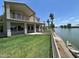 View of the home's backyard, featuring a lush lawn and waterfront access at 1414 N Palmsprings Dr, Gilbert, AZ 85234