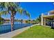 A backyard featuring a view of a lake and grass with a covered porch at 1414 N Palmsprings Dr, Gilbert, AZ 85234