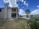 A view of the backyard with a green lawn, a house, and a scenic view of a lake at 1414 N Palmsprings Dr, Gilbert, AZ 85234