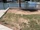 Backyard lawn featuring patchy grass, dirt spots, and a view of the lake at 1414 N Palmsprings Dr, Gilbert, AZ 85234