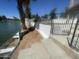 Waterfront property featuring a dock, grassy area, retaining wall, and fenced yard at 1414 N Palmsprings Dr, Gilbert, AZ 85234