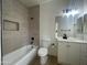 Bathroom featuring tile accents in the shower/tub and a modern vanity and lighting fixture at 1414 N Palmsprings Dr, Gilbert, AZ 85234