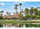 Val Vista Lakes clubhouse and community center with a lake and waterfall, surrounded by palm trees at 1414 N Palmsprings Dr, Gilbert, AZ 85234